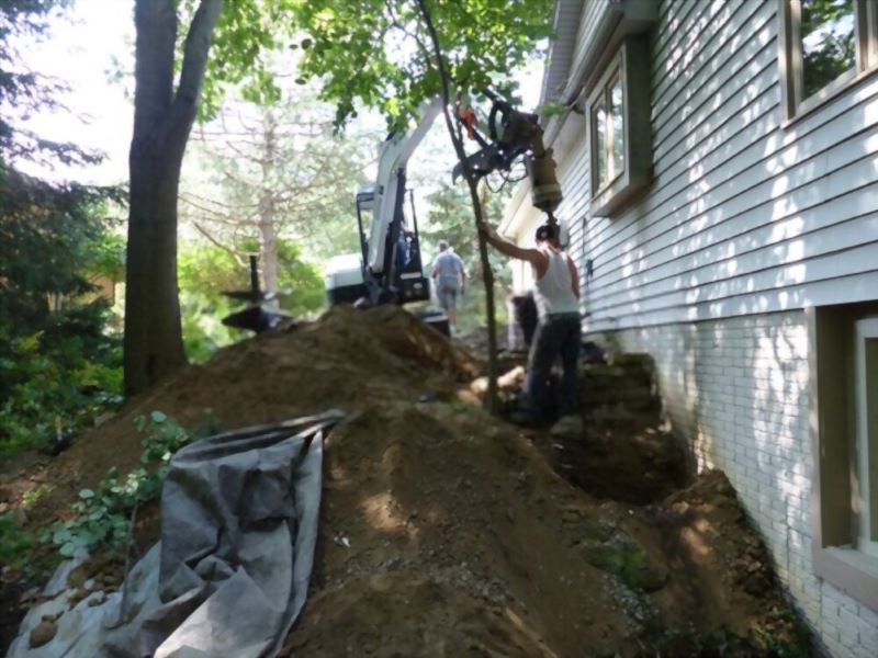 workers digging beside the house